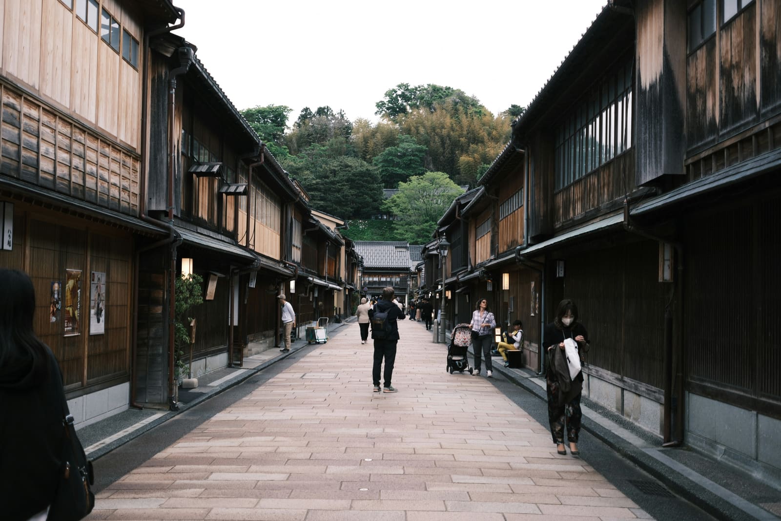 Traditional wooden lattice facades along a cobbled street in the Higashi Chaya District of Kanazawa