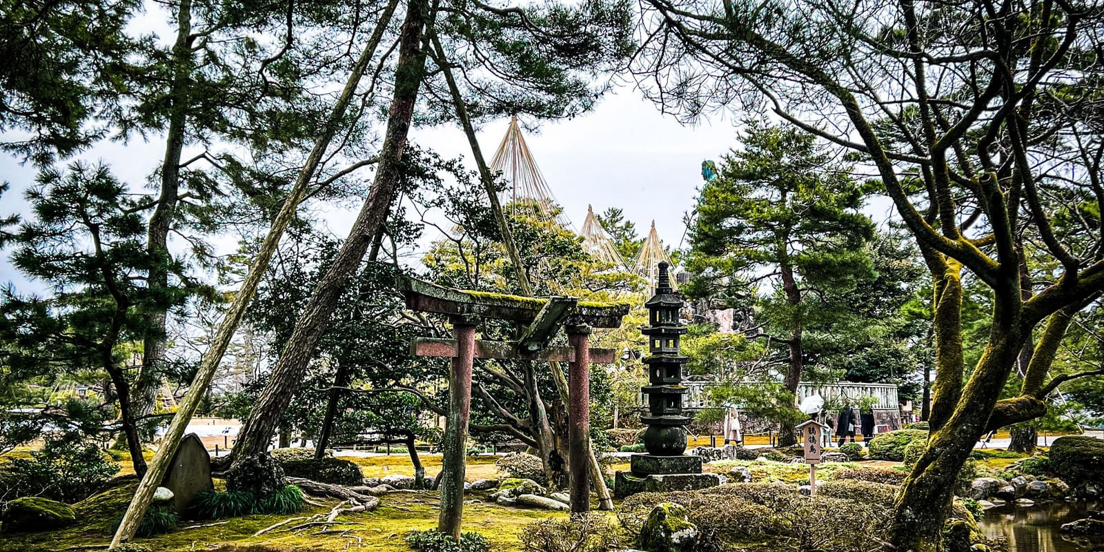 Kotoji-toro two-legged stone lantern beside Kasumigaike pond at Kenroku-en Garden in Kanazawa