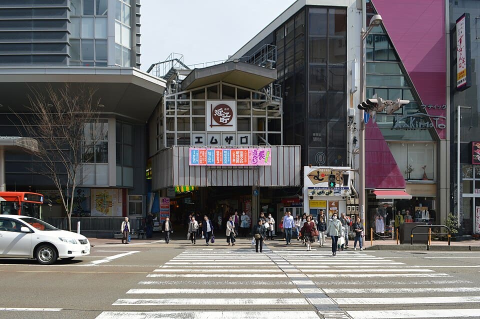 Covered arcade entrance to Omicho Market with hanging signs and seafood stalls in Kamiomicho, Kanazawa