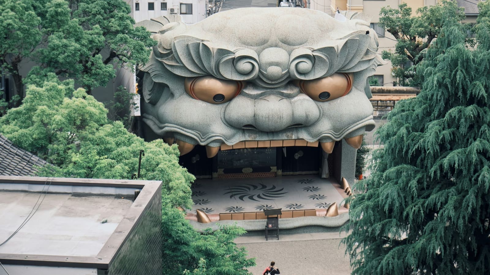 Namba Yasaka Shrine prayer hall and vermilion details surrounded by the urban Namba district of Osaka, Japan