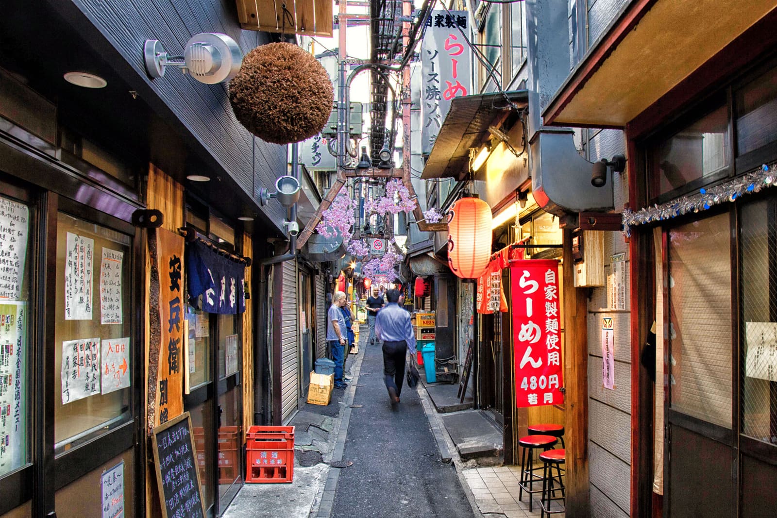 Golden Gai narrow alleyways with glowing bar signs and lanterns at night in Shinjuku, Tokyo, Japan
