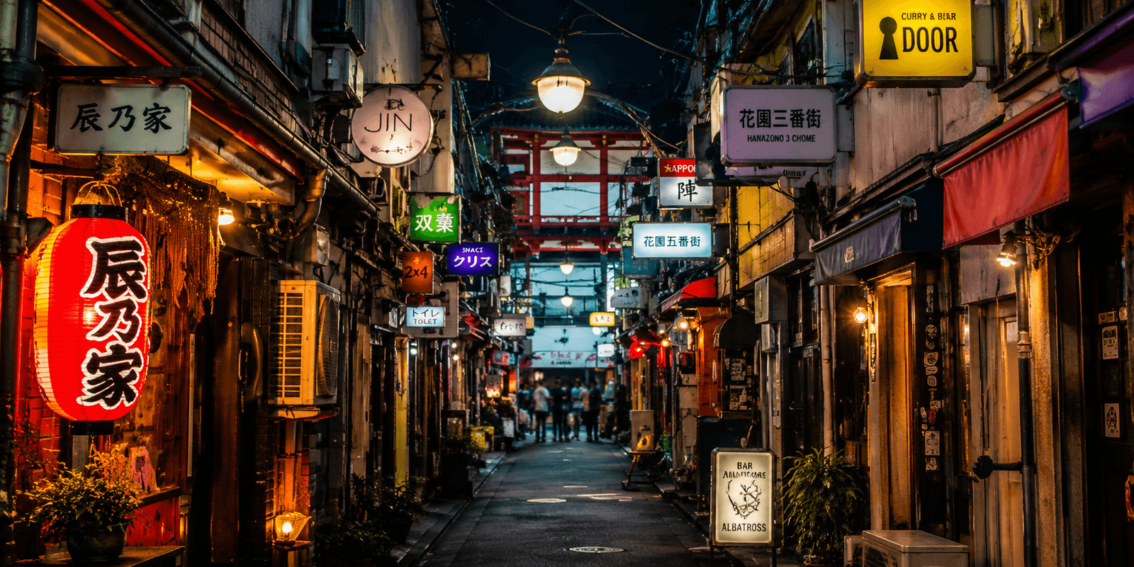 Golden Gai's narrow lantern-lit alleyways with glowing bar signage at night, Shinjuku, Tokyo, Japan