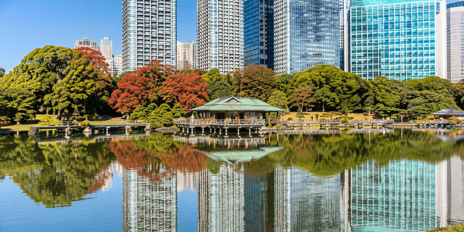Shioiri-no-ike tidal pond and the Nakajima-no-Ochaya tea house at Hamarikyu Gardens, framed by Shiodome skyscrapers, Chuo, Tokyo, Japan