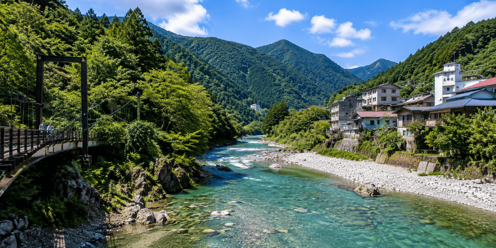 A suspension footbridge over a clear turquoise river in the forested mountains of Okutama, with traditional riverside lodges below the peaks, Tokyo, Japan
