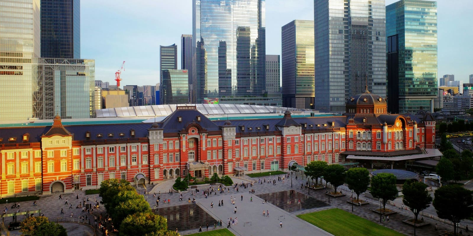 The red brick Marunouchi building of Tokyo Station in front of the Marunouchi office towers