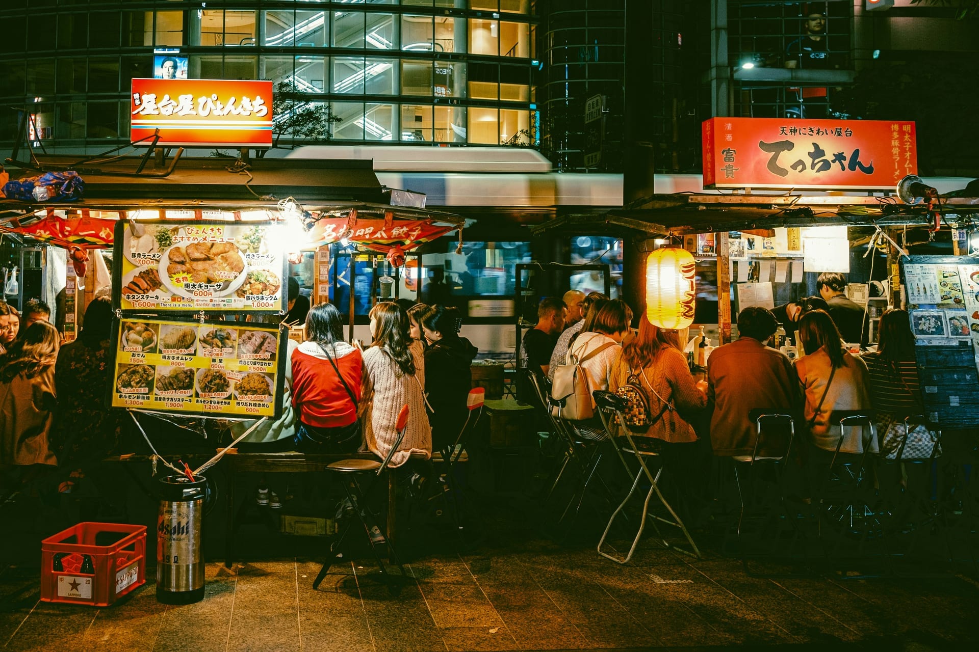Nakasu yatai food stalls along the river at night in Fukuoka