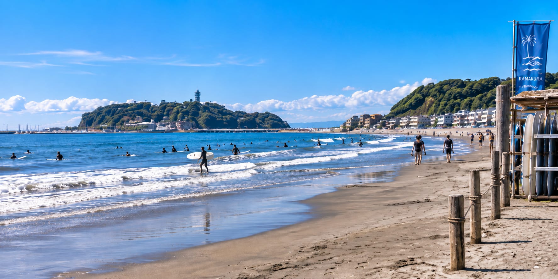 Sandy shoreline of Yuigahama Beach in Kamakura, with the coastline and, weather permitting, Mount Fuji or Enoshima Island visible in the distance
