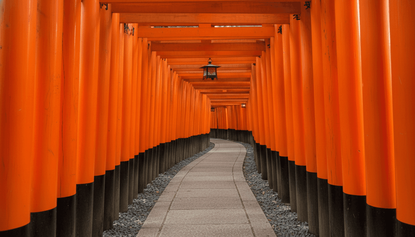 Stone kitsune fox statues and torii gate inscriptions along the mountain trail at Fushimi Inari Taisha, Kyoto