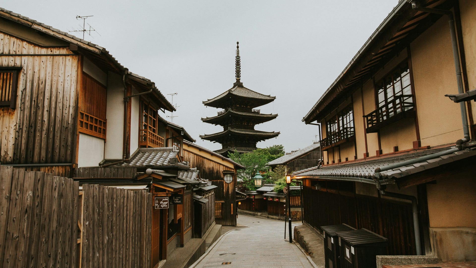 Hanamikoji Street in Gion lined with traditional machiya townhouses and paper lanterns glowing in the evening, Kyoto