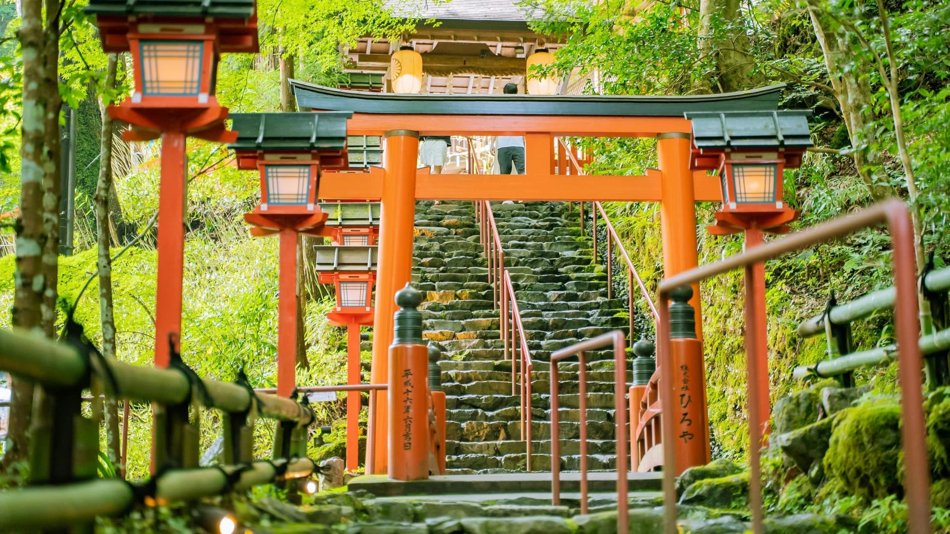 Red lanterns lining the stone stairway approach to Kifune Shrine in the Kibune valley
