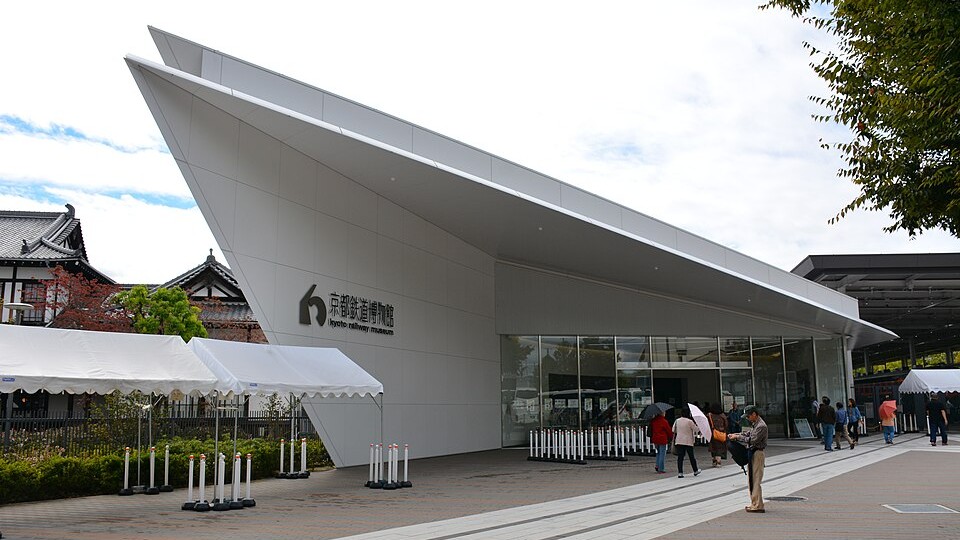 Visitors exploring the outdoor Promenade area with historic train carriages at Kyoto Railway Museum