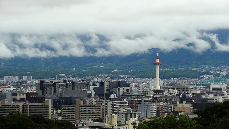 360-degree panoramic view from Kyoto Tower observation deck showing the city basin surrounded by forested mountains