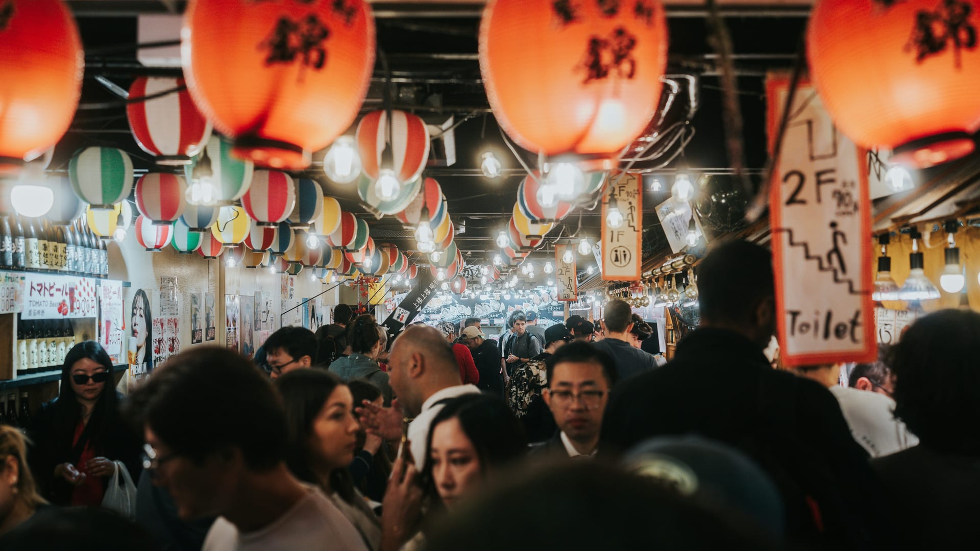 Nishiki Market covered shopping arcade bustling with food stalls and vendors in central Kyoto