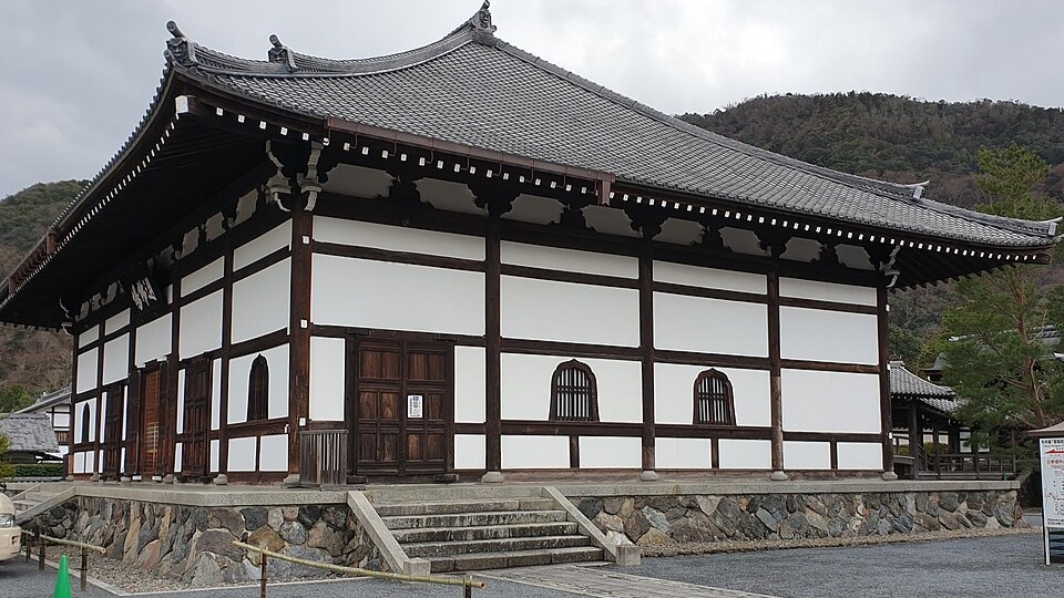 Wooden veranda at Tenryu-ji Temple overlooking the garden pond surrounded by autumn foliage
