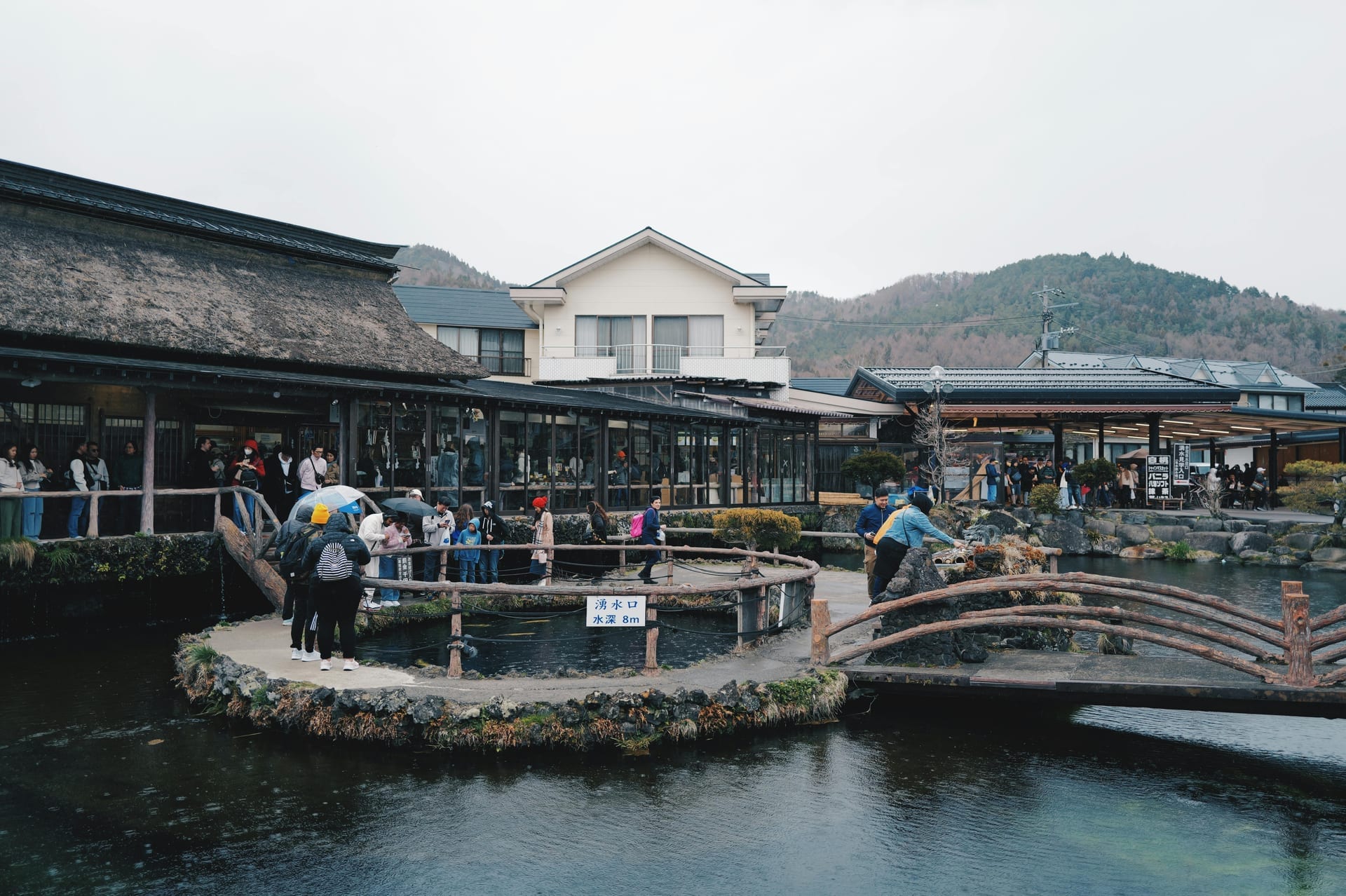 Oshino Hakkai crystal clear spring ponds with traditional thatched-roof buildings and Mount Fuji Japan