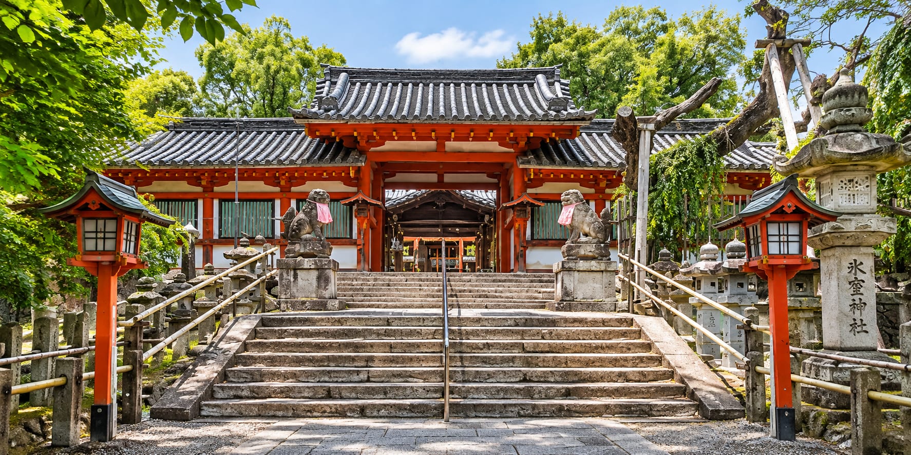 Himuro Shrine vermilion gate with stone komainu guardians Nara Japan