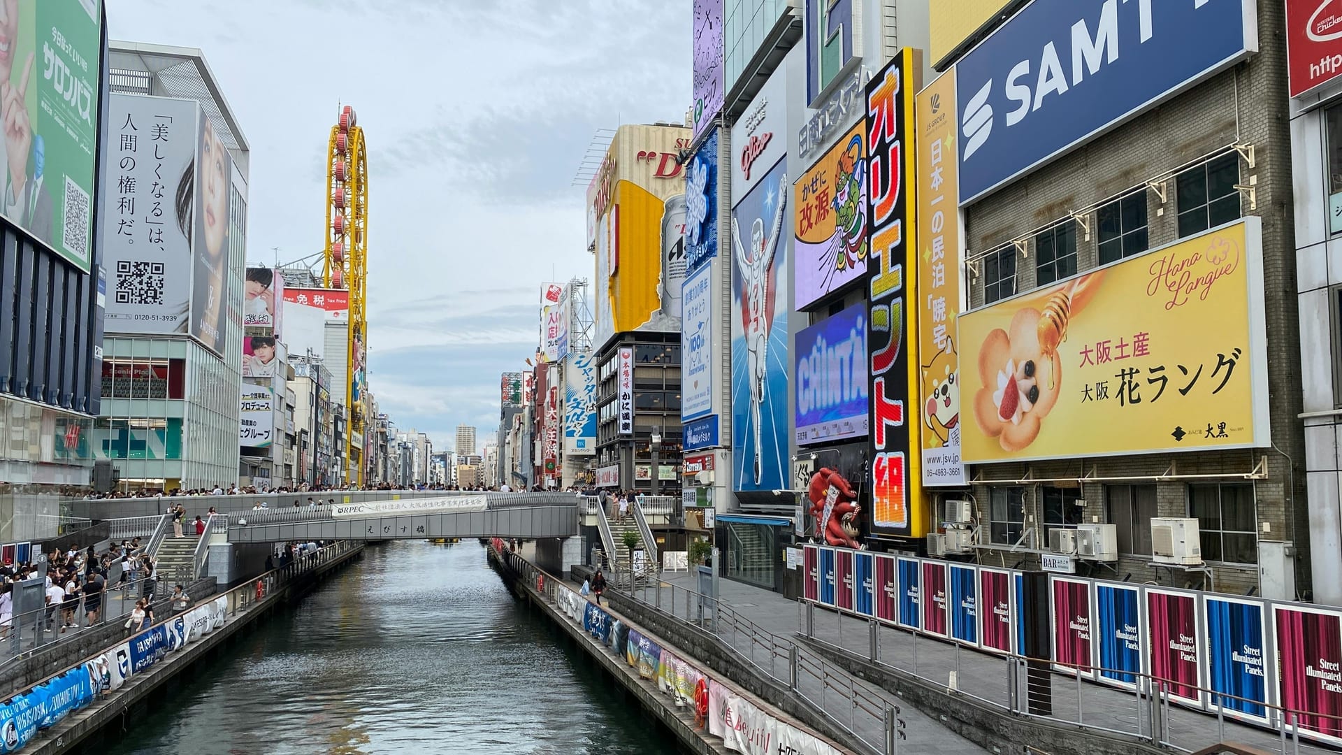 Glico Running Man illuminated sign overlooking Ebisu Bridge and the Dotonbori Canal, Osaka