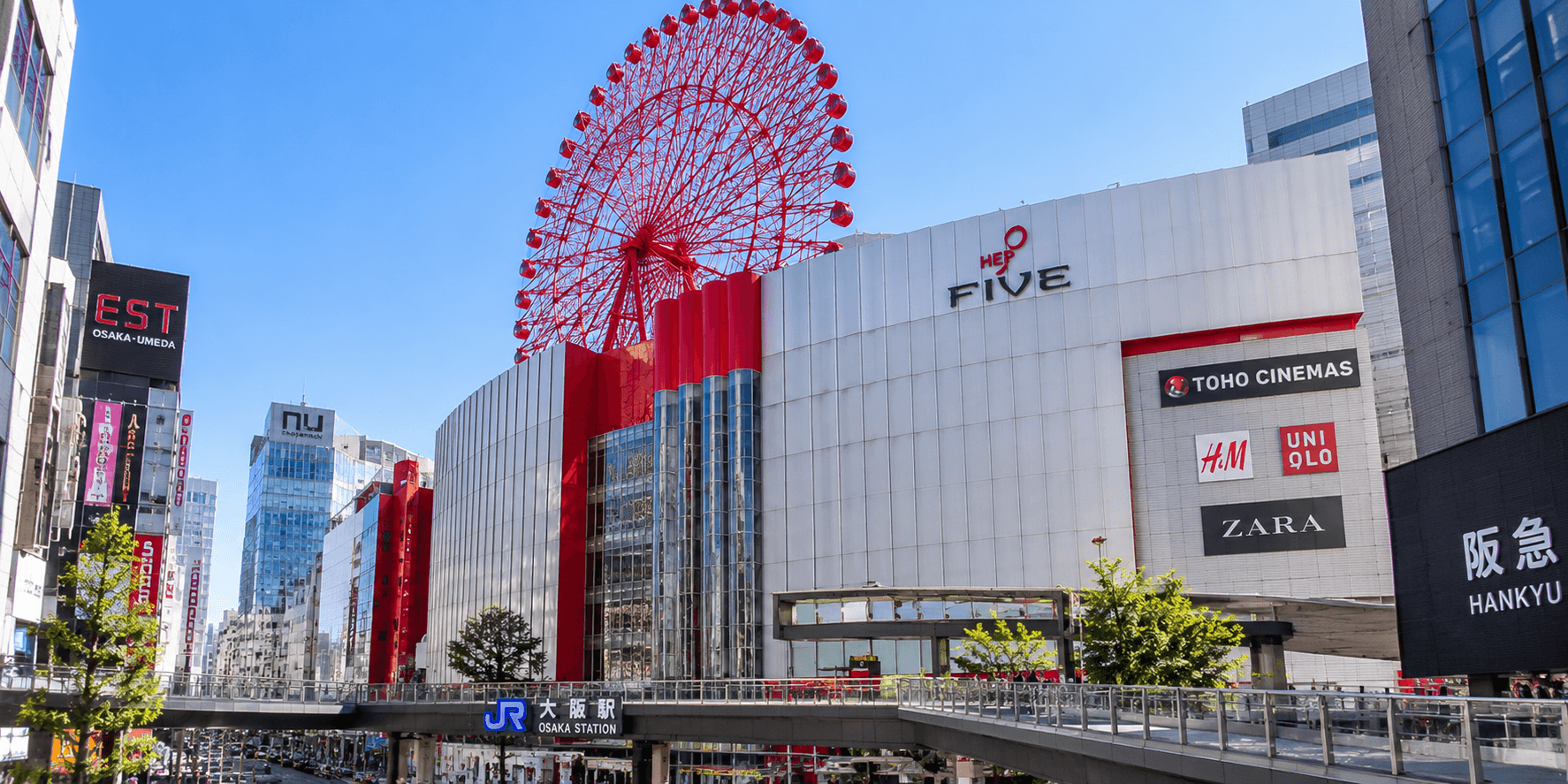 Bright red Ferris wheel mounted on the rooftop of the HEP FIVE shopping building in Umeda, Osaka Japan