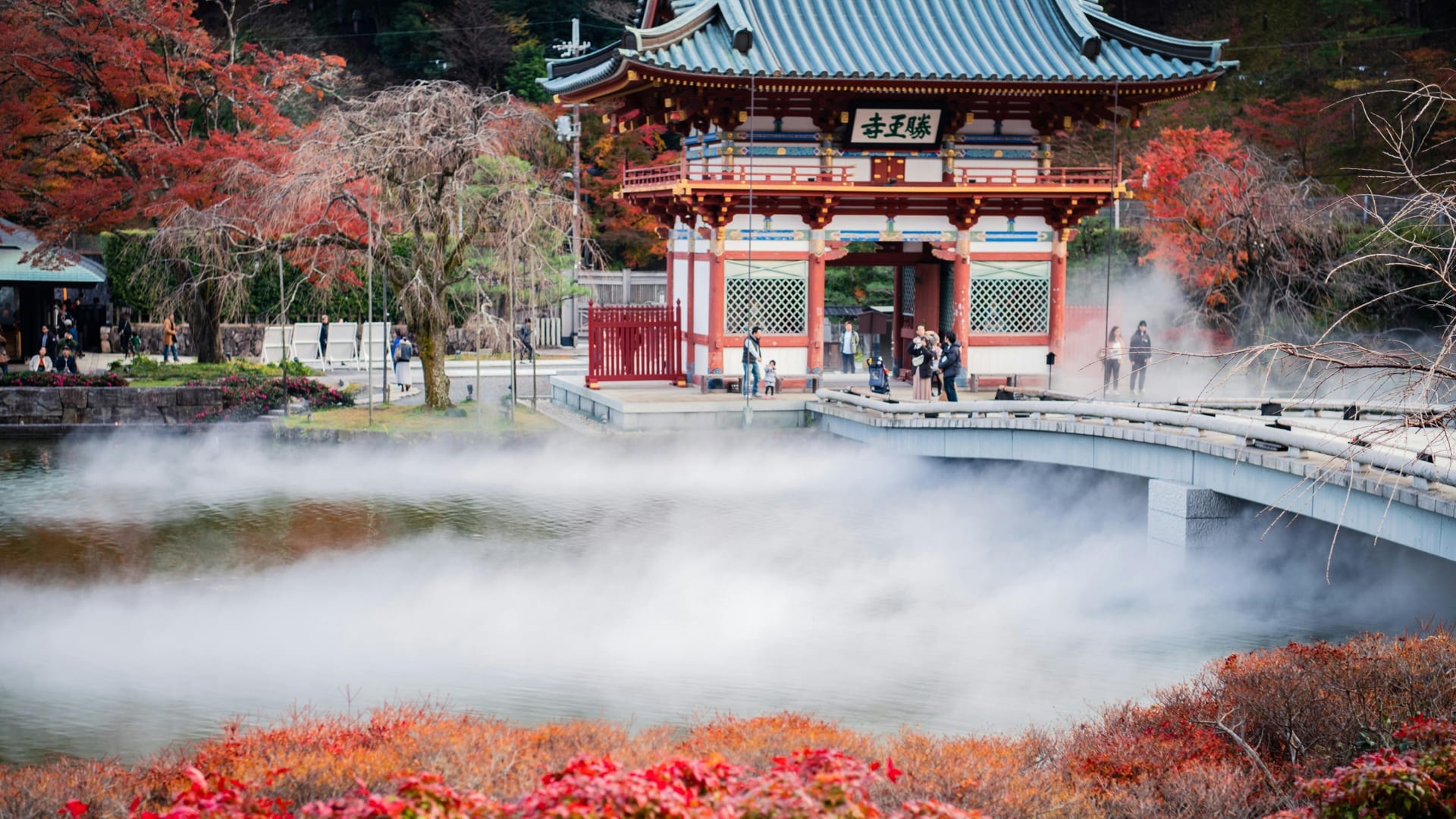 Minoo Waterfall cascading 33 meters into a rocky basin surrounded by dense forest and autumn foliage, Osaka Japan