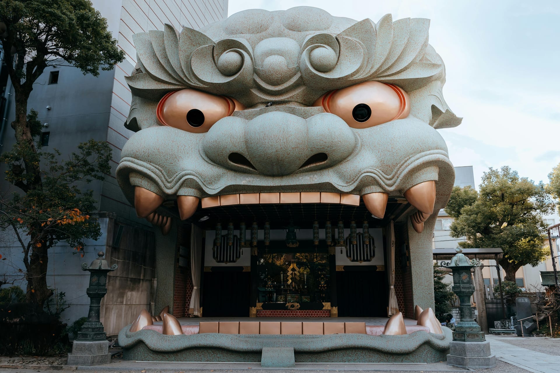 Namba Yasaka Shrine giant lion head stage with open mouth forming the main stage, one of Osaka's most visually striking shrines, Japan