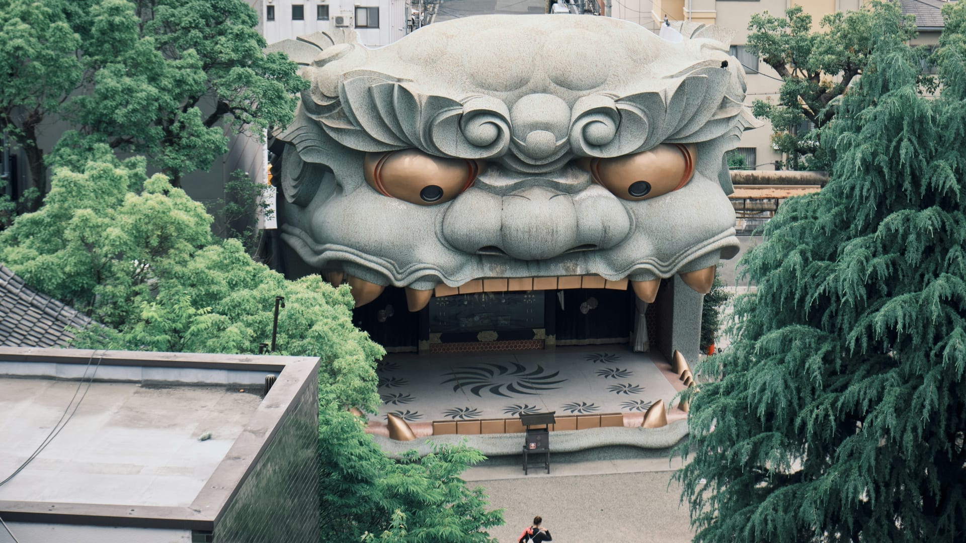 Namba Yasaka Shrine prayer hall and vermilion details surrounded by the urban Namba district of Osaka, Japan