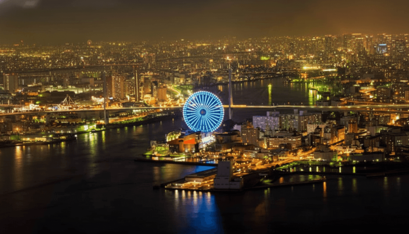 Tempozan Harbor Village waterfront with Osaka Bay ferris wheel illuminated at dusk and shopping complex below, Japan