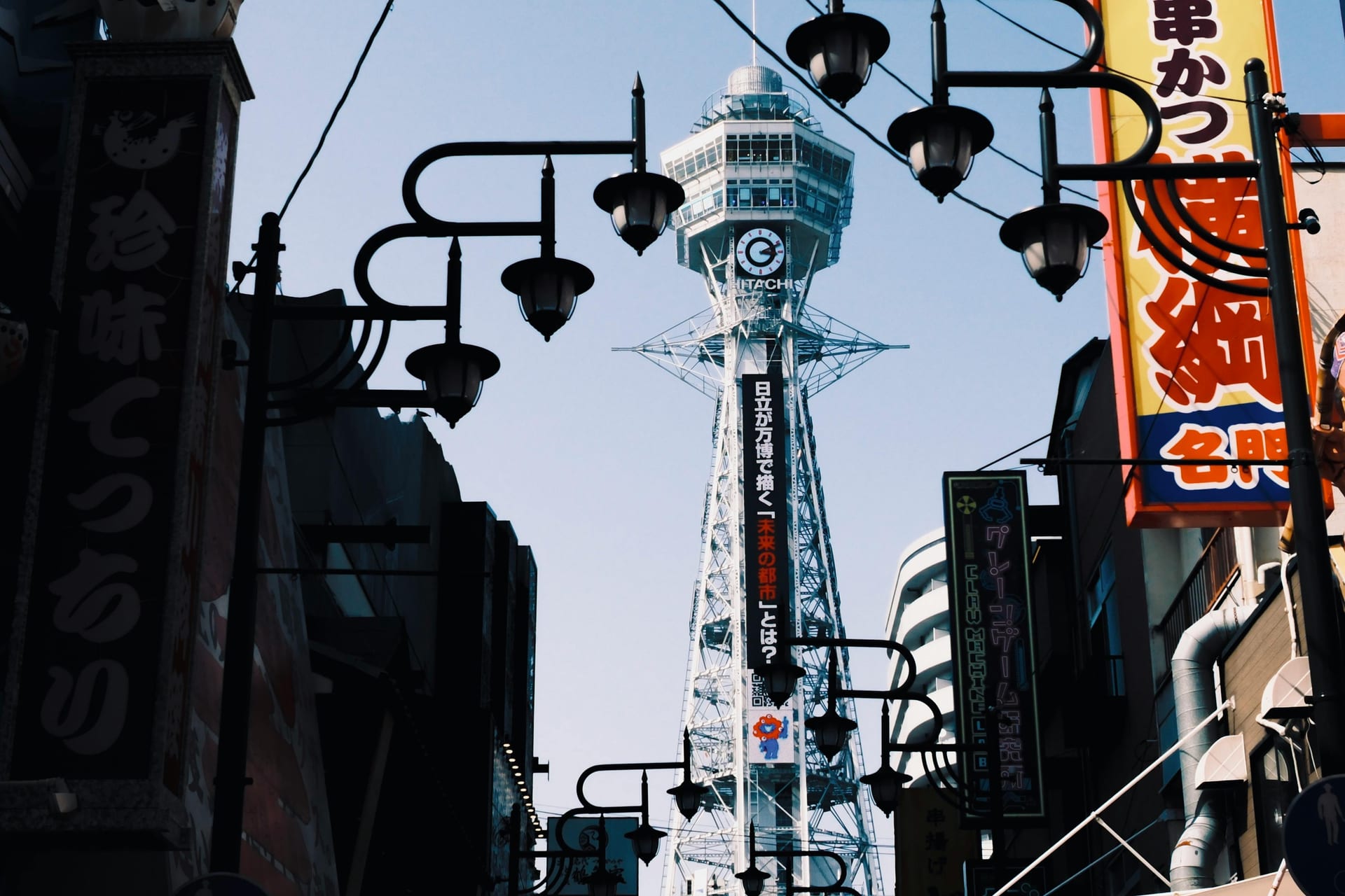 Shinsekai district narrow streets with vertical neon signs and retro storefronts, Osaka Japan