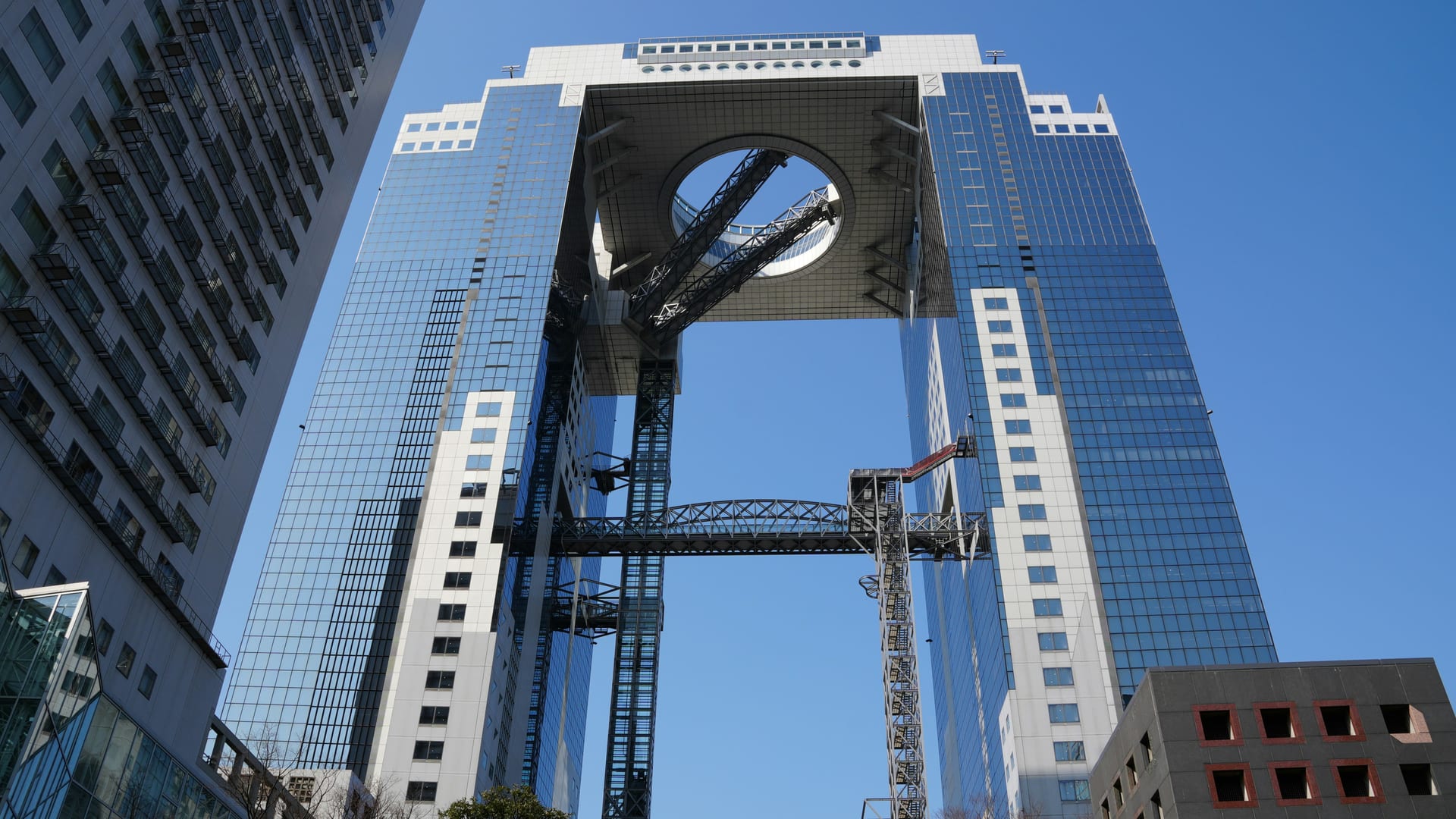 Umeda Sky Building floating garden observatory at night with panoramic Osaka city lights visible below, Japan