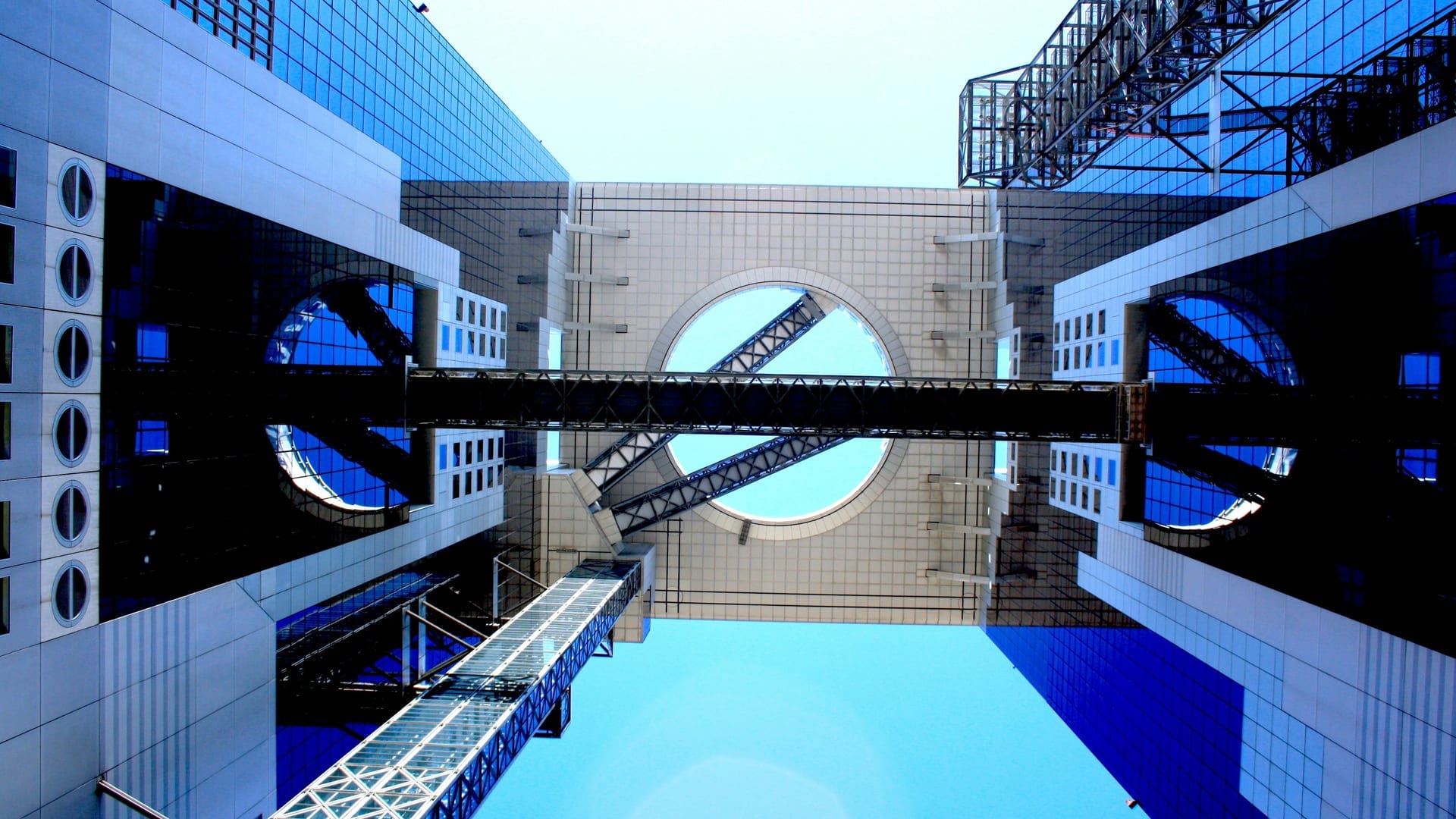 Glass escalators crossing the open sky between Umeda Sky Building's twin towers, Osaka Japan