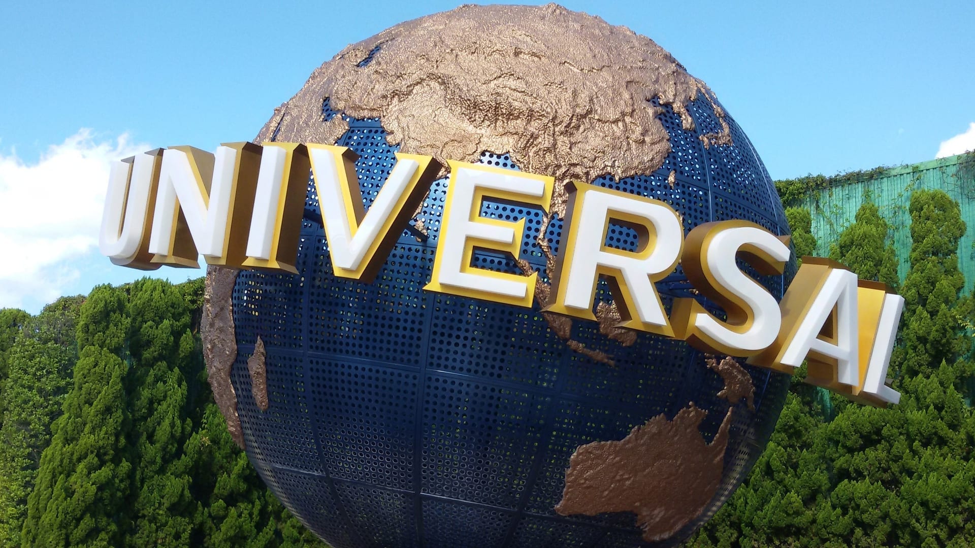 Universal Studios Japan entrance globe with colorful theme park in background, Osaka Japan
