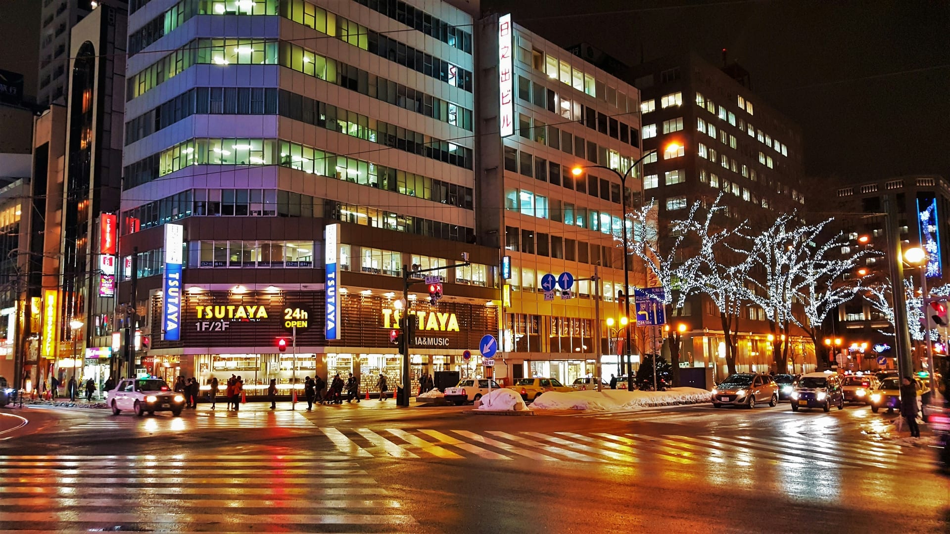 Susukino district illuminated at night with snow on the streets