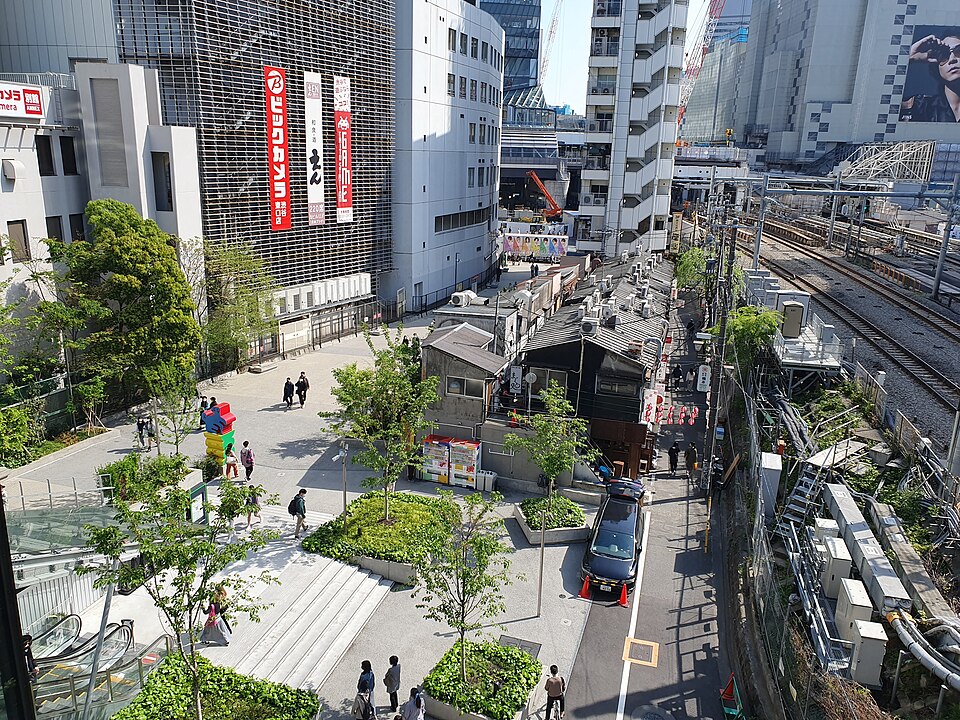 Busy street-level view of the Shibuya district near Miyashita Park with crowds and city buildings
