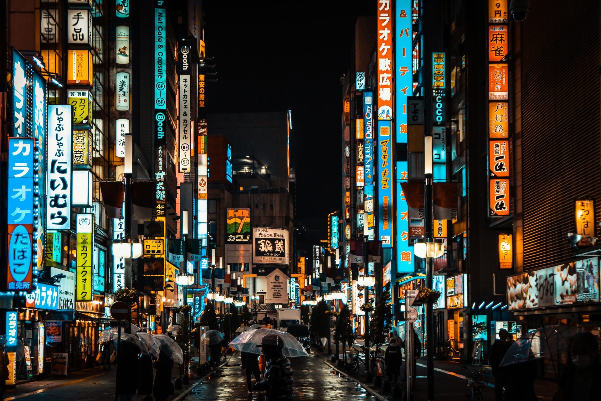 Neon-lit Kabukicho street in Shinjuku, Tokyo, on a rainy night